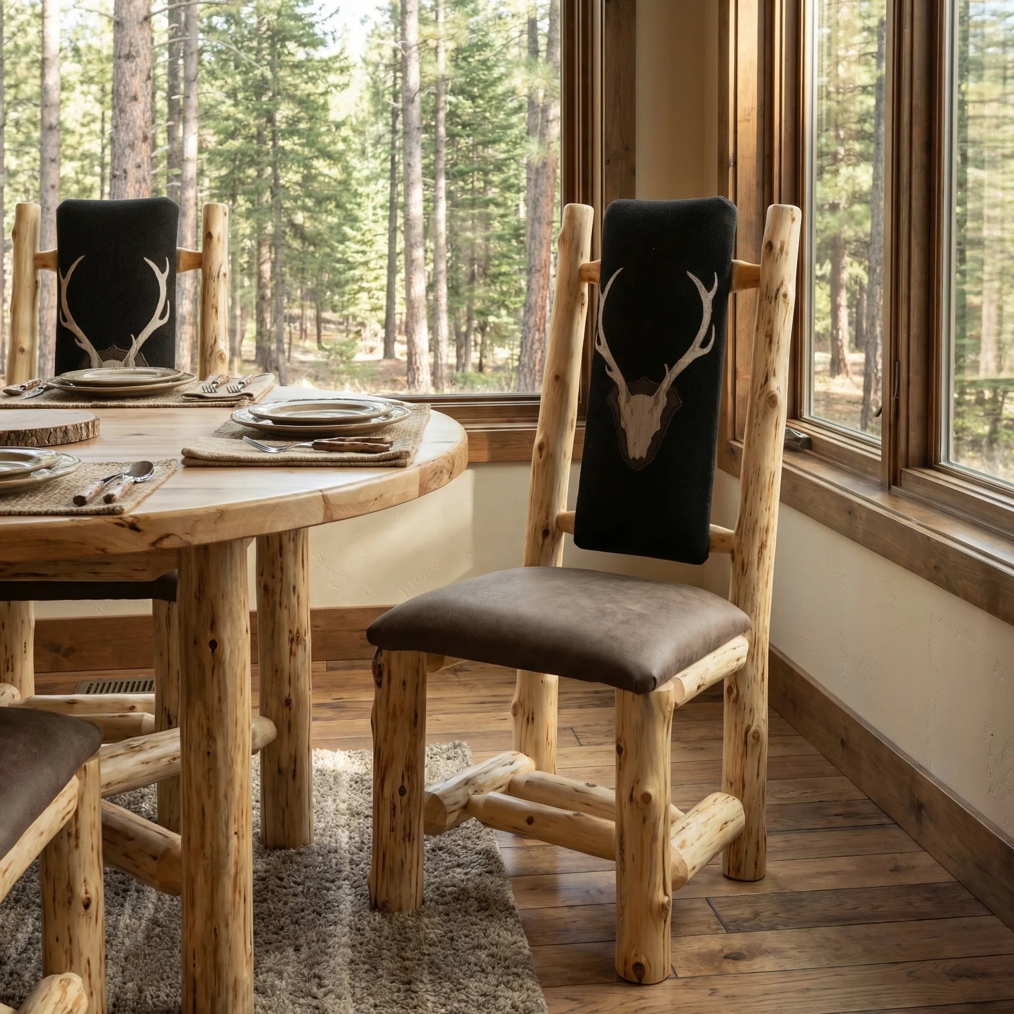Cedar log dining chair with staghorn fabric back and leather seat in rustic lodge dining room
