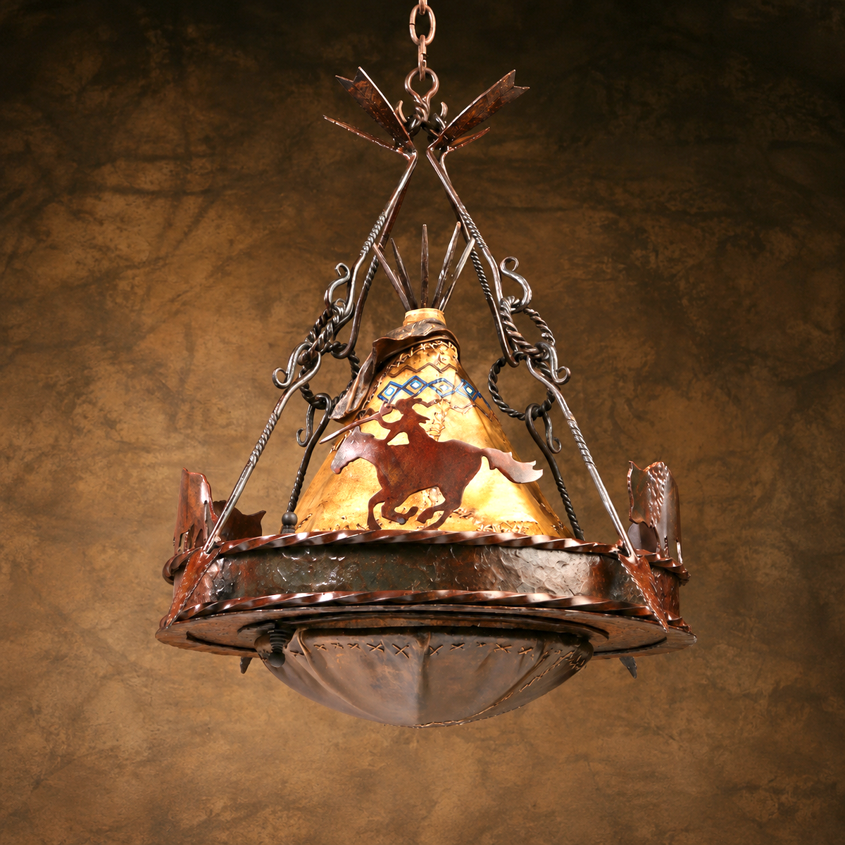 A rustic Native American-inspired metal chandelier pendant light with a warm yellow-gold stained glass cone featuring a brown horse rider motif, hanging from an ornate dark metal frame against a textured brown background.