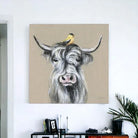 Canvas print of a cow with a bird on its head against a beige background - Your Western Decor