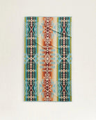 Pendleton Highland Peak organic cotton velour towel featuring turquoise, cream, rust, and black Southwestern pattern.
