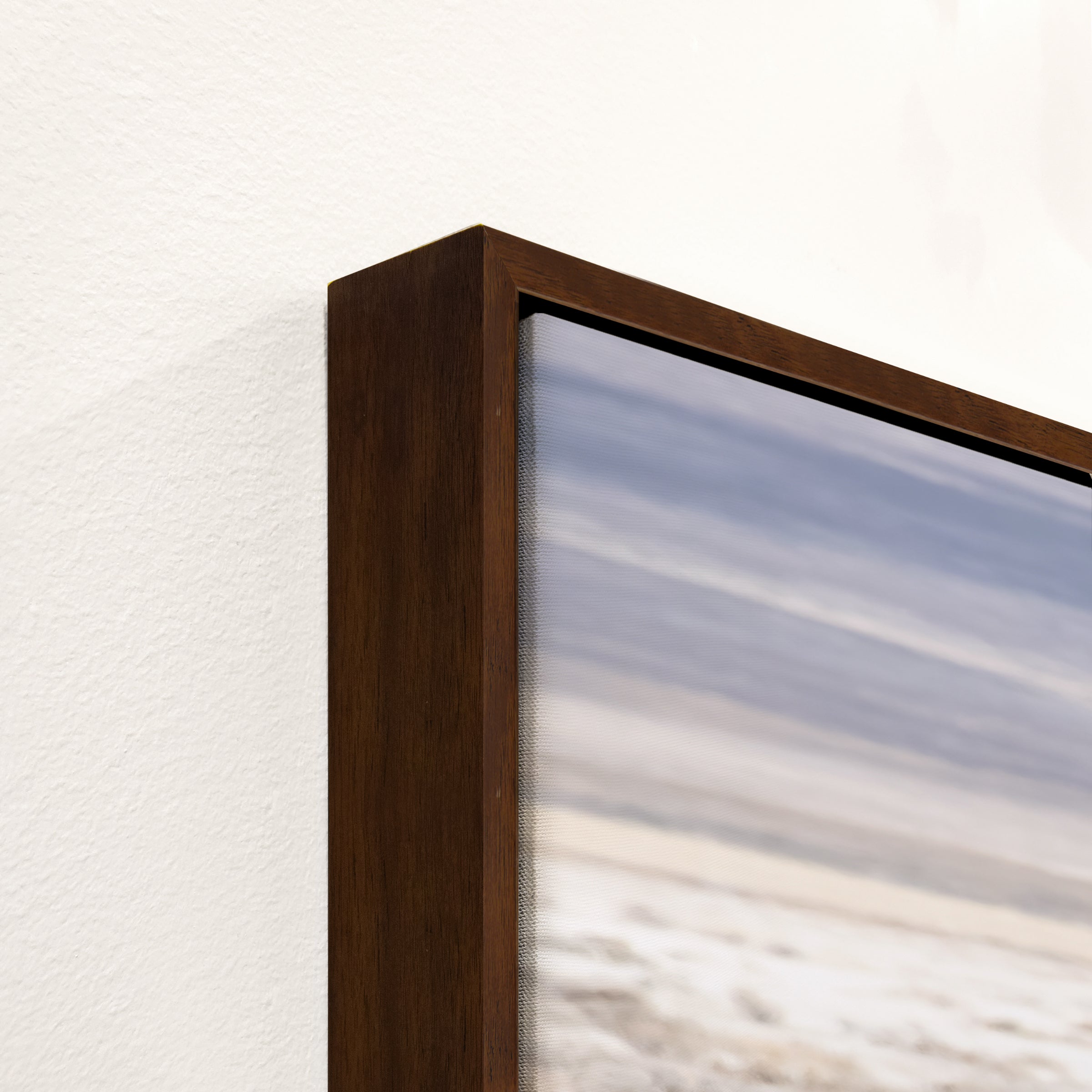 Close up of wood floater frame on canvas art - Your Western Decor