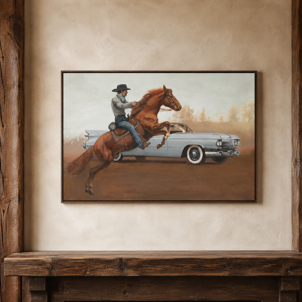 A framed art print depicting a cowboy riding a brown horse while chasing a light blue classic car, displayed on a textured beige wall above a rustic wooden mantel.