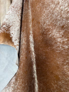 Close up of brown and white peppered cowhide rug