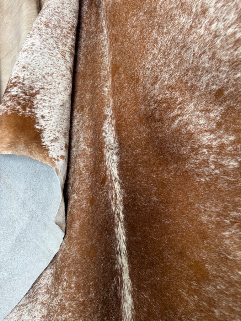 Close up of brown and white peppered cowhide rug