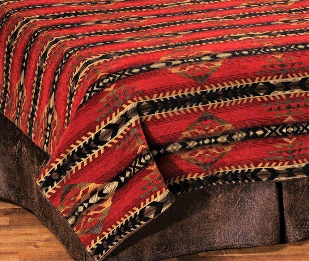 Red patterned blanket on a wooden bed frame