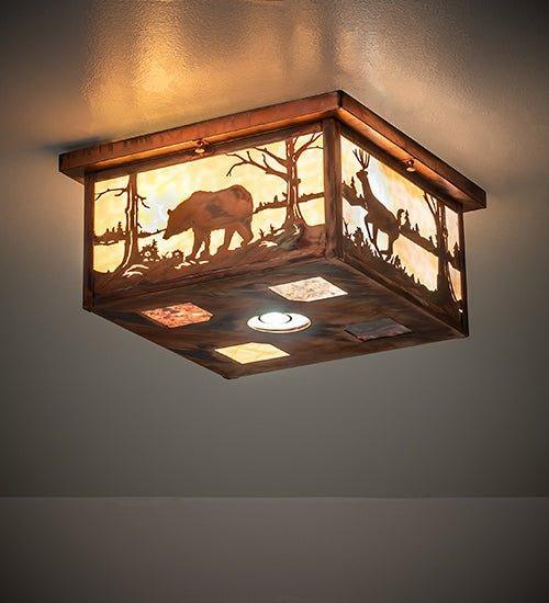 A square ceiling light fixture with a rustic wood frame and warm glowing glass panels featuring silhouettes of a bear and trees, mounted on a ceiling.