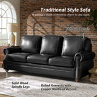 Black leather sofa with solid wood spindle legs and rolled armrests in a room with brick wall and window.