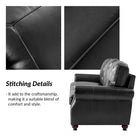 Black leather armchair with close-up of stitching details on a white background