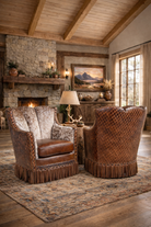 Iron Spur Diamond Quilted Leather & Peppered Cowhide Swivel Chairs with fringe in rustic living room 