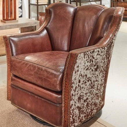 Brown leather swivel chair with peppered brown white cowhide