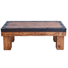 Rustic handmade beam-style coffee table with metal trim and iron rivets
