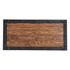 top detail of rustic wood coffee table with iron trim and iron rivets 
