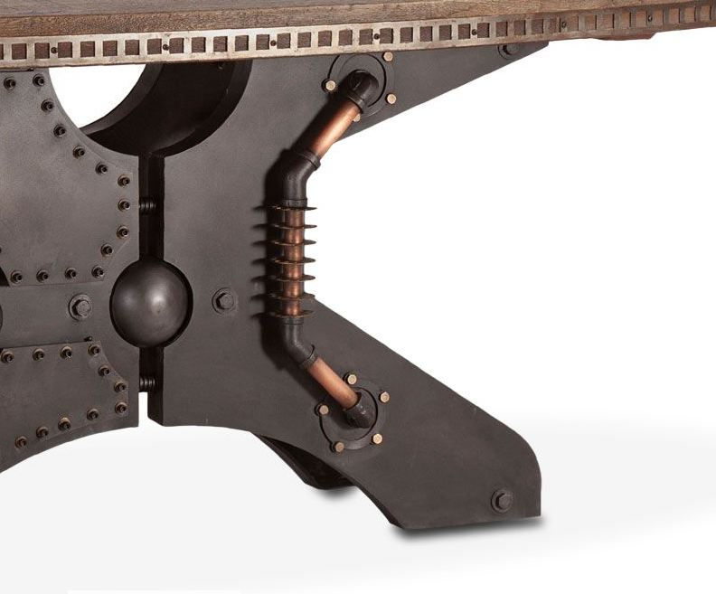 Close-up of a dark industrial table leg with rivets, a large round weight, and copper-colored pipe accents on a white background.