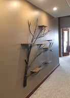 Rustic iron wall shelf tree branch design with wood shelves in ranch home