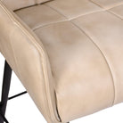 Close up of ivory leather on swivel counter stool 
