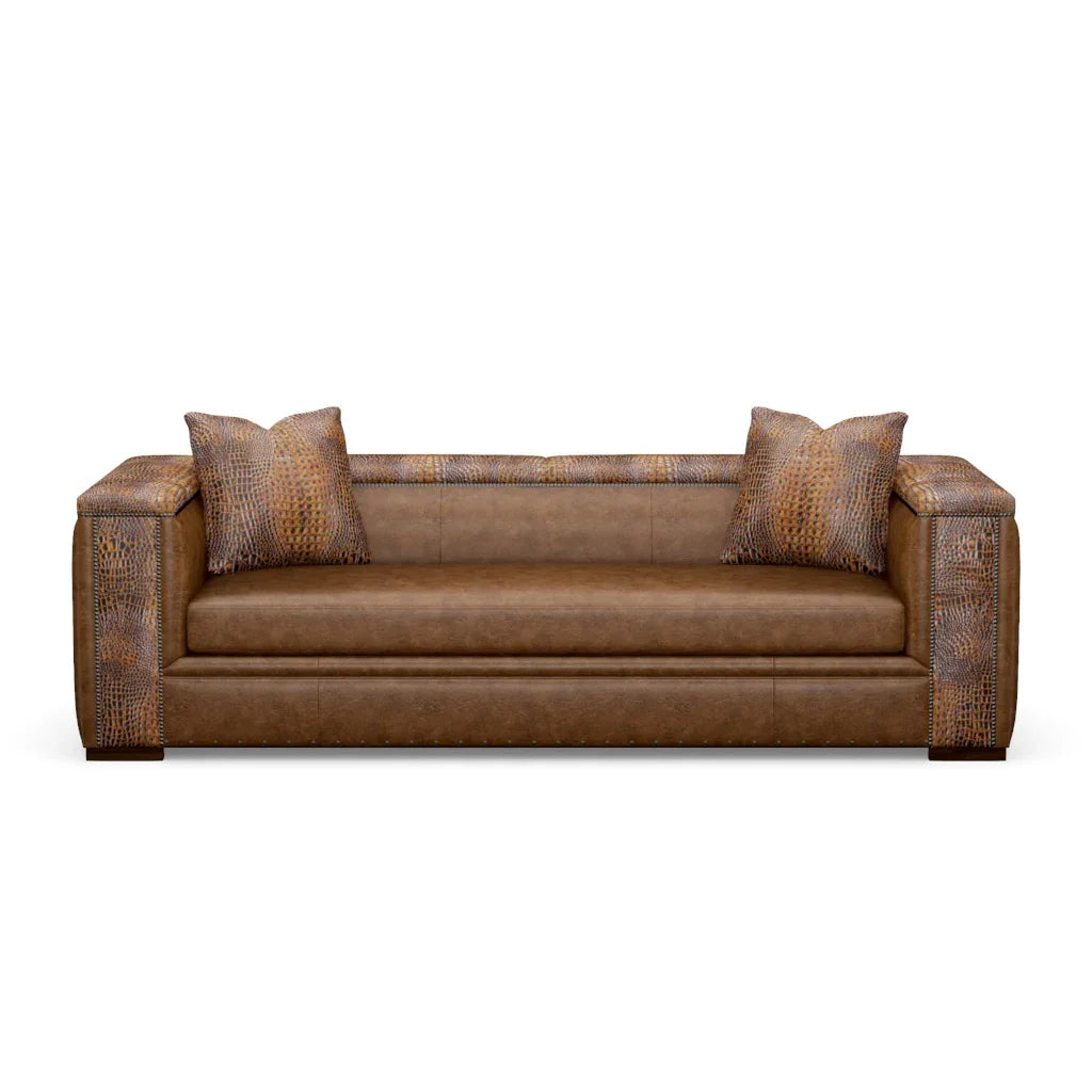 Brown leather sofa with patterned armrests and pillows on a white background - Your Western Decor 