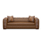 Brown leather sofa with patterned armrests and pillows on a white background - Your Western Decor 