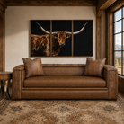 Brown leather sofa with one cushion, croc accents, and nail trim. Shown with Tryptich Longhorn Art and longhorn rustic side table 