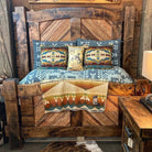 Rustic wooden bed with patterned bedding and pillows against a wooden wall - Your Western Decor