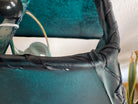 Close up of top corner of teal-green rawhide lamp shade