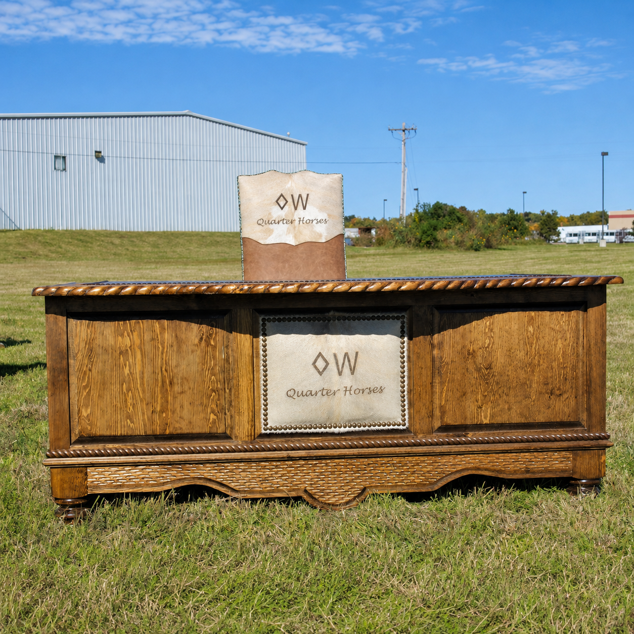 western desk and chair upholstered with leather, nailhead trim, and laser branded cowhide 