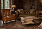 Living room with custom leather chair, sofa, and Wyeth Trail ottoman and Golden Lab