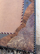 Close of detail of nail trim, leather, and cowhide western mirror corner