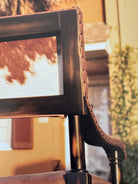 Brown white cowhide back and smooth leather exposed wood accent chair detail