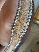 Detail nail and embossed leather trim on swivel glider chair - Your Western Decor