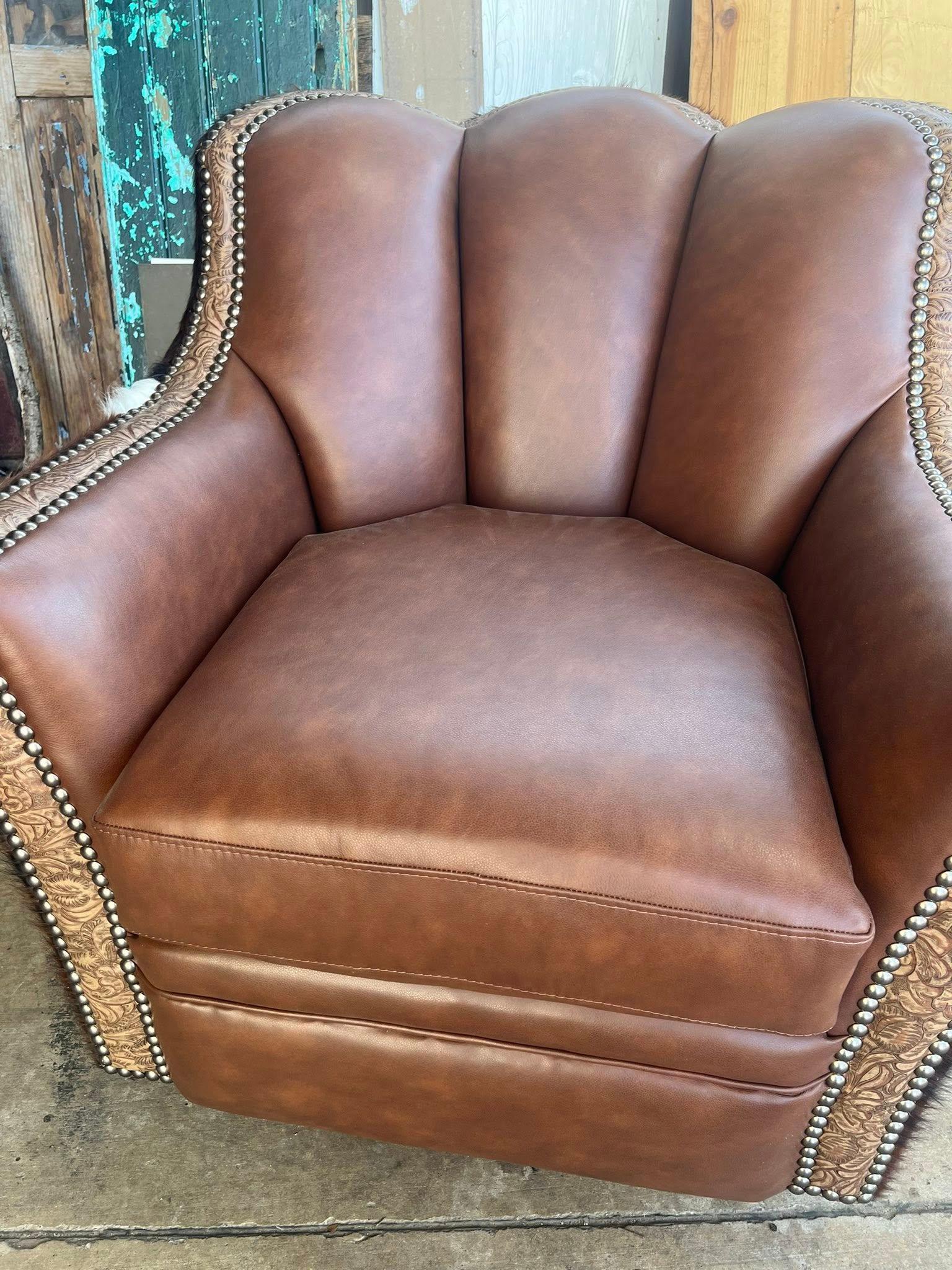 Brown leather armchair with decorative stitching on a rustic background - Your Western Decor