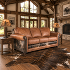 Leather sofa with dark brindle cowhide sides, back, and front rail, in western themed living room 