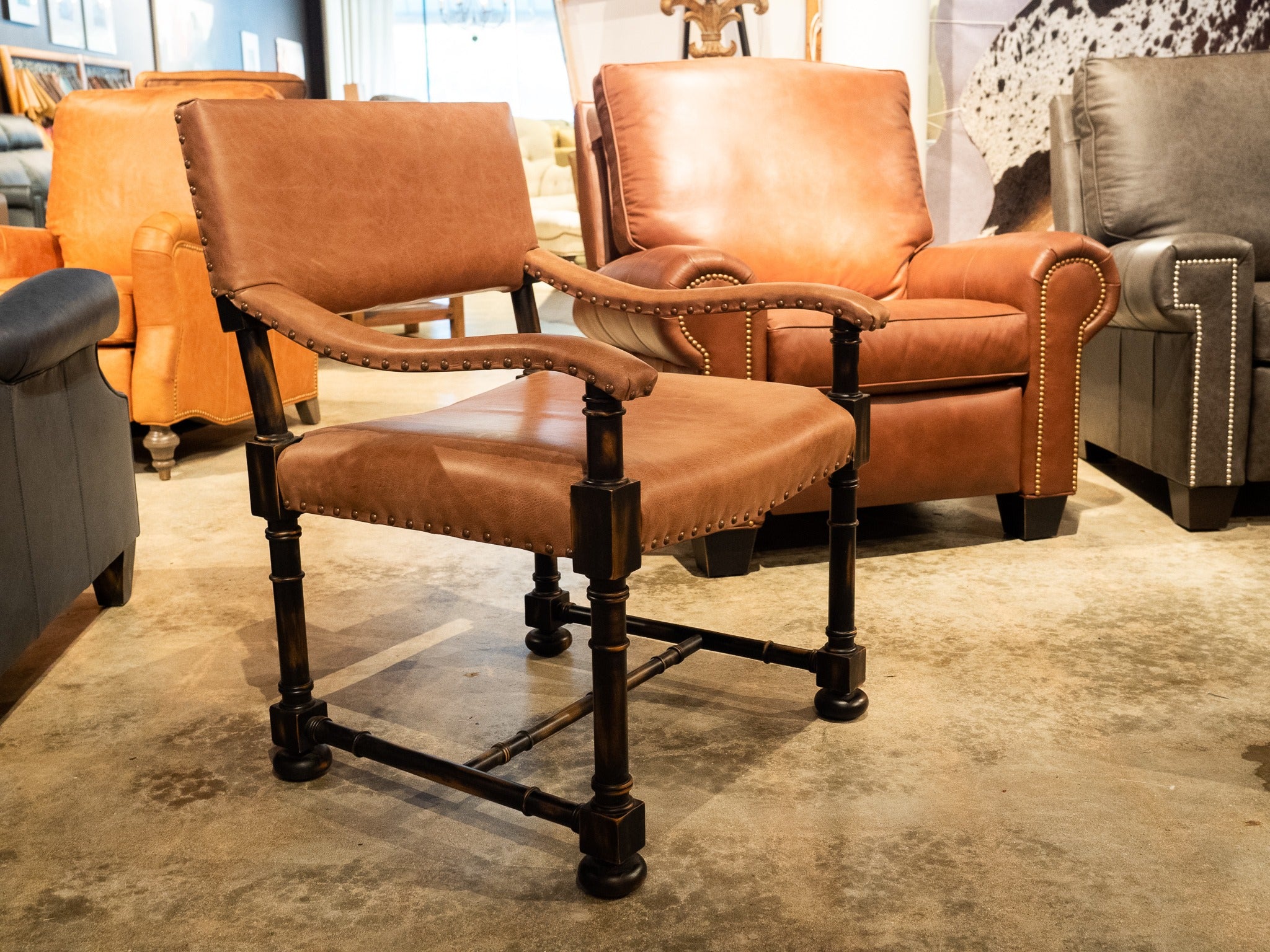 Rancho custom chair in chestnut leather with cowhide back and nail trim