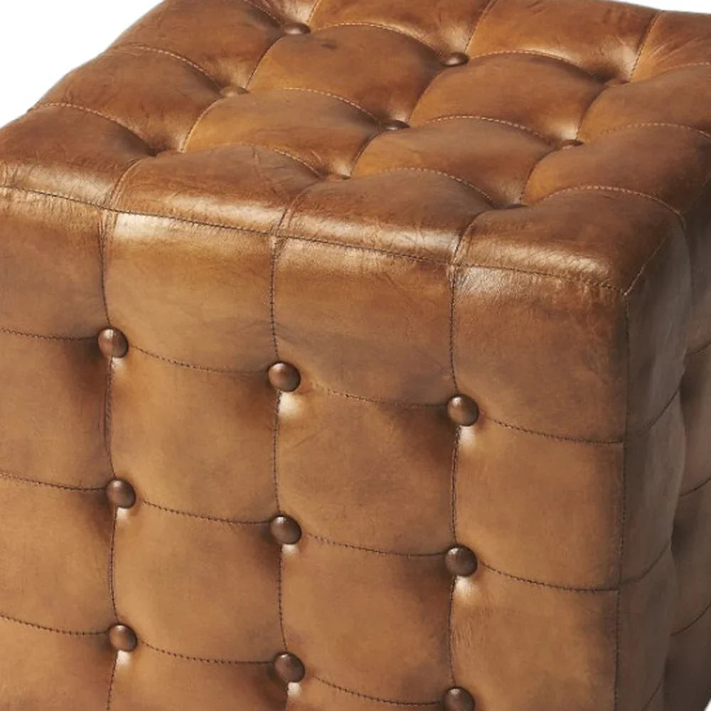 Close-up of a brown leather ottoman with tufted design - Your Western Decor
