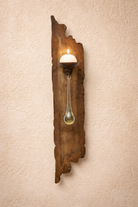 Decorative wall sconce with a rustic wooden design on a beige wall - Your Western Decor
