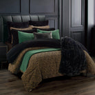 Bed with leopard print and green comforter in a darkly decorated room - Your Western Decor