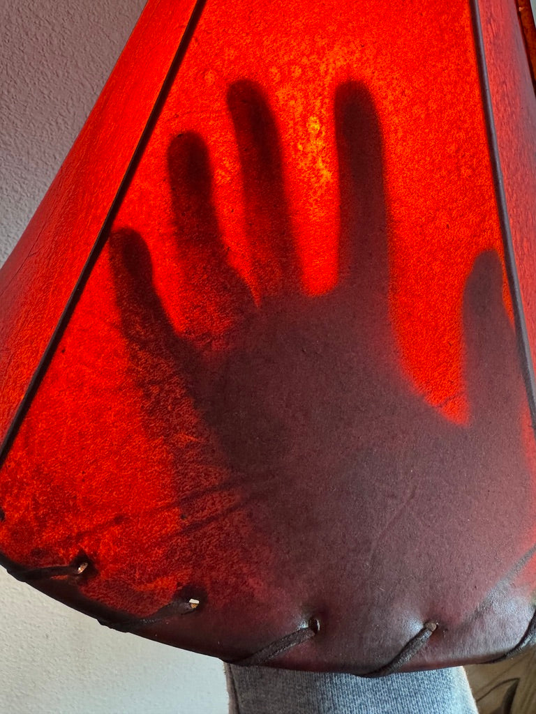 Lit amber rawhide lamp shade image showing transparency 