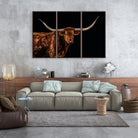 Living room with a large sofa and wall art of a longhorn bull - Your Western Decor