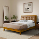 Wooden bed with tufted headboard in a bedroom setting 