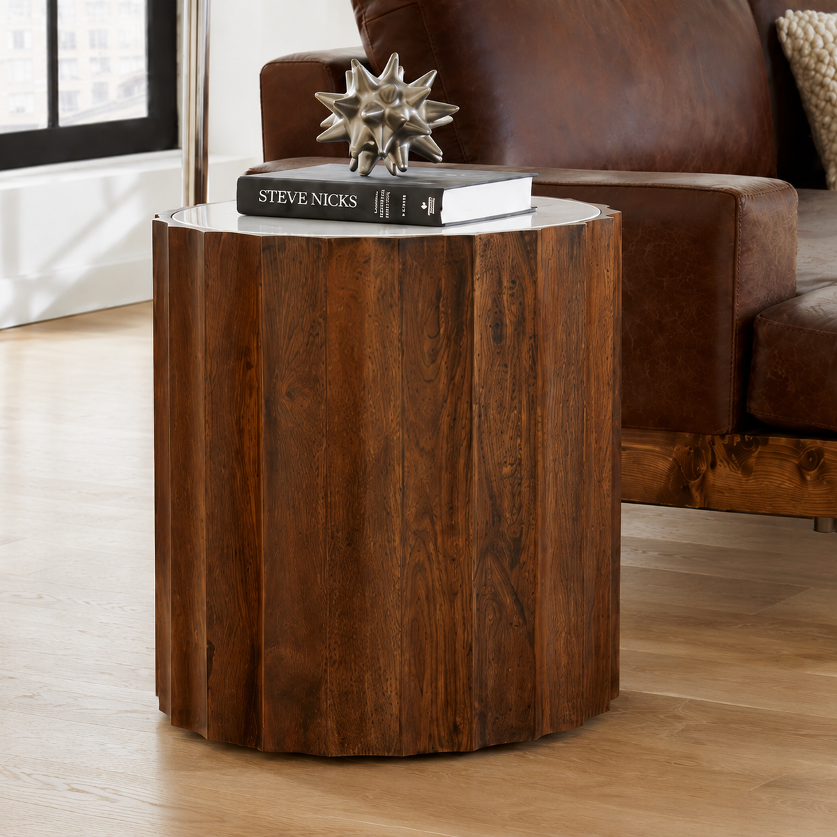 Fluted mango wood and white marble side table beside a brown leather sofa