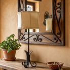 Hand forged Western table lamp with burnt metal finish with white cylinder rawhide lamp shade