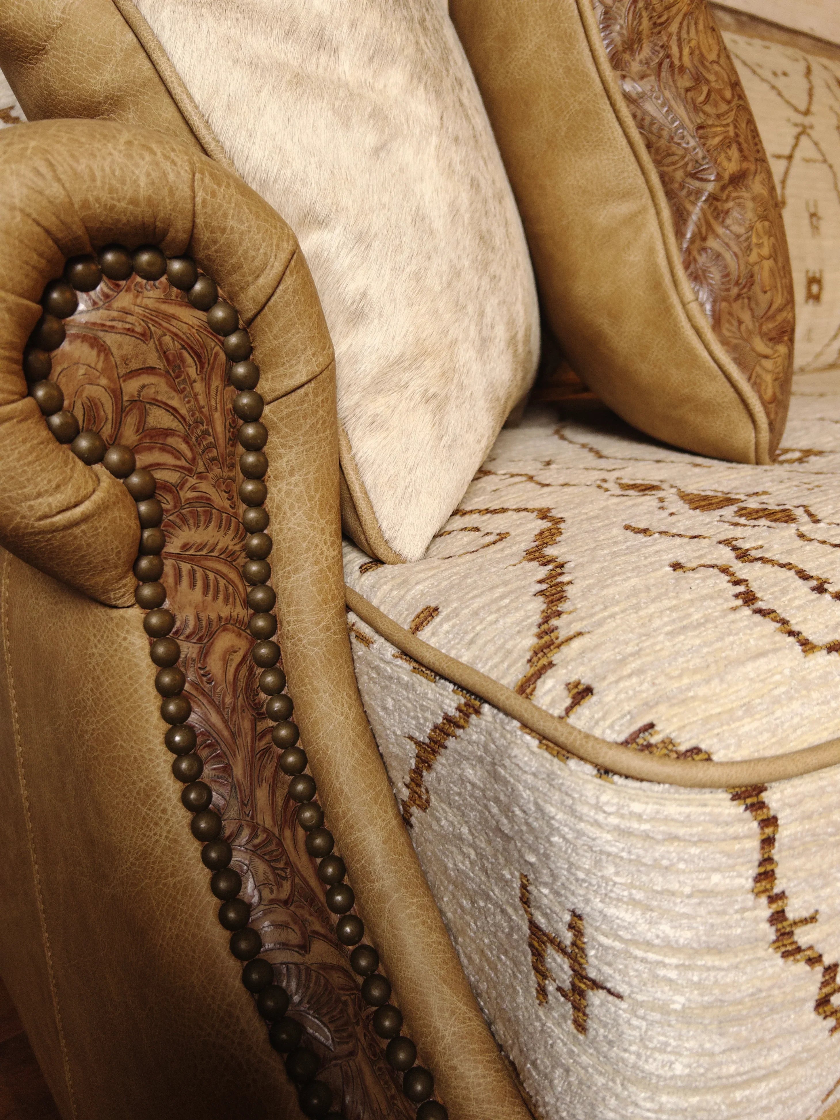 Close up of Mesa sofa showing Mesa southwestern fabric, smooth and embossed leathers, and nail trim