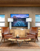 Leather chairs and console, desert art and wood slab coffee table in sitting room - Your Western Decor