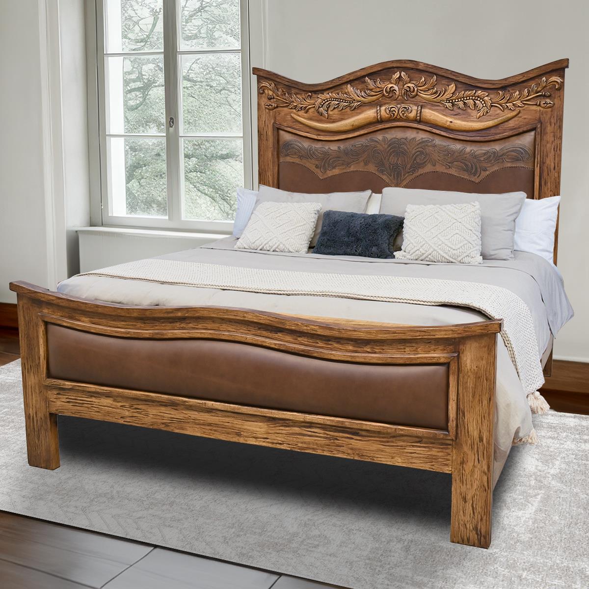 Western bed with hand carved western designs and smooth leather on footboard and smooth and tooled leather on headboard