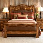 carved wood bed with carved longhorns and leather panels 