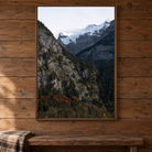 Framed canvas art of one autumn mountain and one winter mountain coming together 