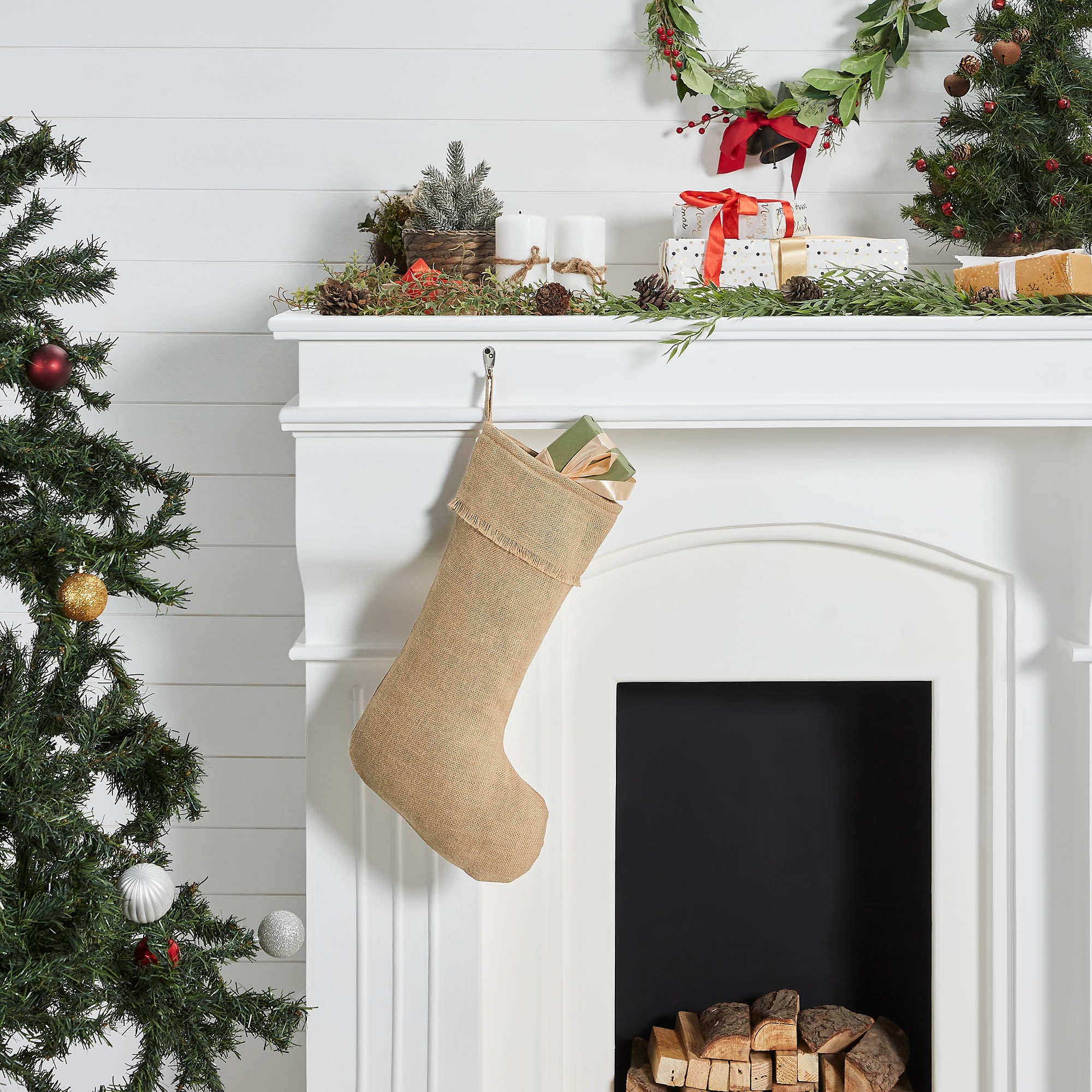 Decorated Christmas mantel with stockings and wreaths on a white fireplace - Your Western Decor