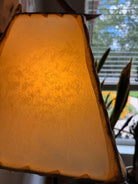 Natural rawhide lamp shade detail with light on