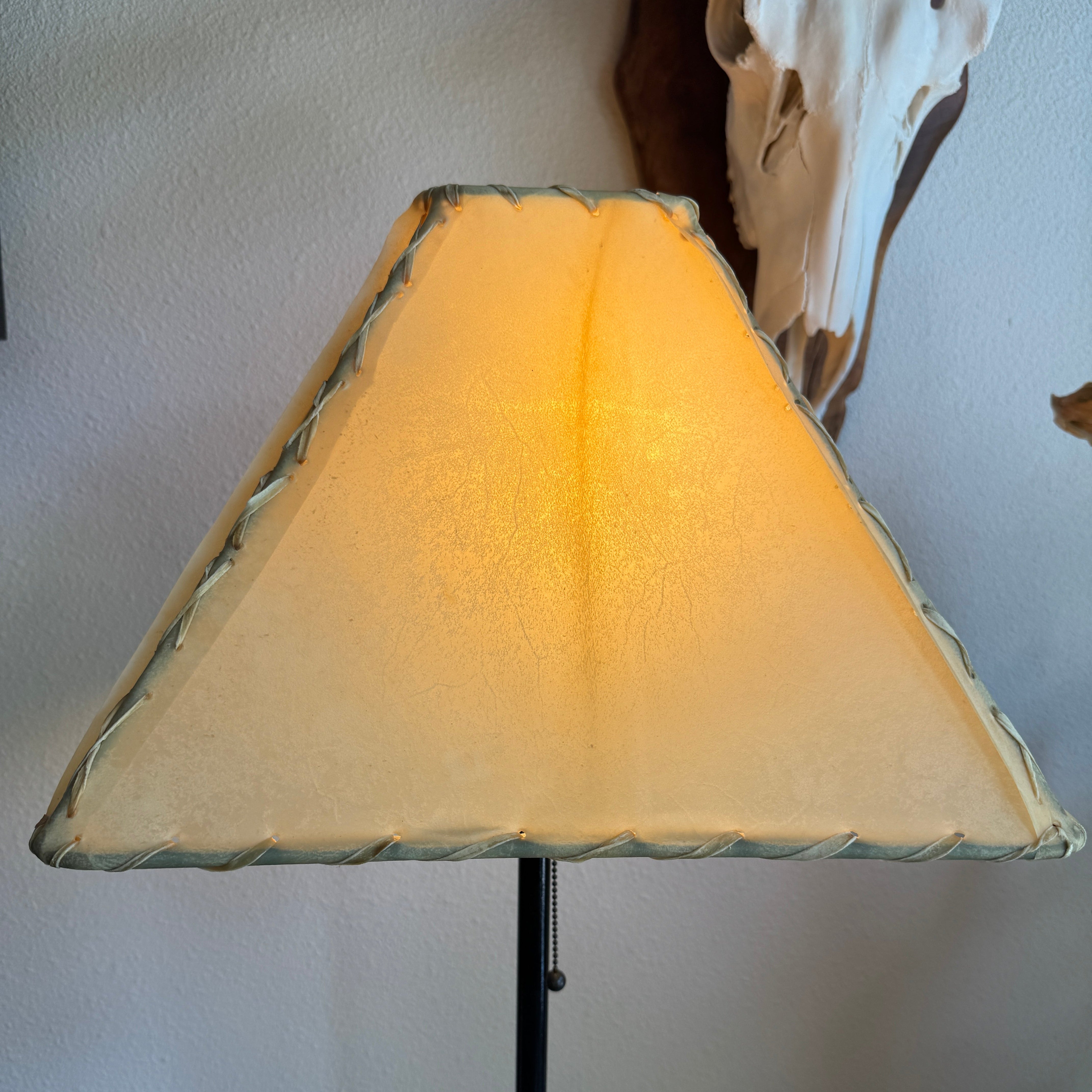 Natural rawhide Southwestern lamp shade with light on 