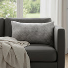 Rectangle grey cowhide accent pillow on grey sofa