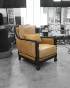 Vintage-style armchair with beige cushion in a showroom setting - Your Western Decor